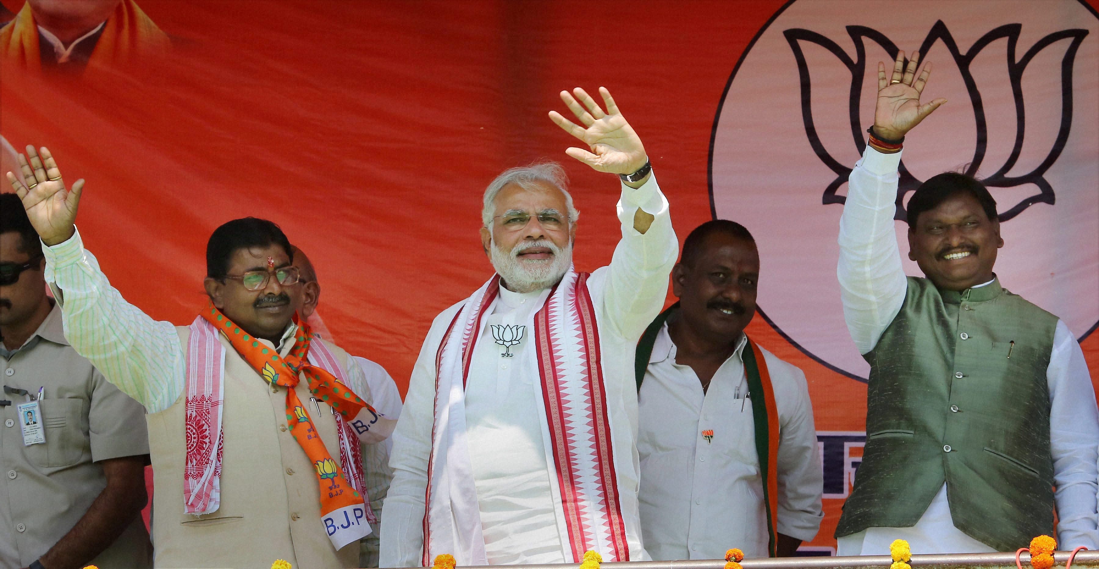 BJP's PM candidate Narendra Modi waves to supporters during an election campaign rally in Koderma, Jharkhand (Photo: PTI) BJP's PM candidate Narendra Modi waves to supporters during an election campaign rally in Koderma, Jharkhand (Photo: PTI)